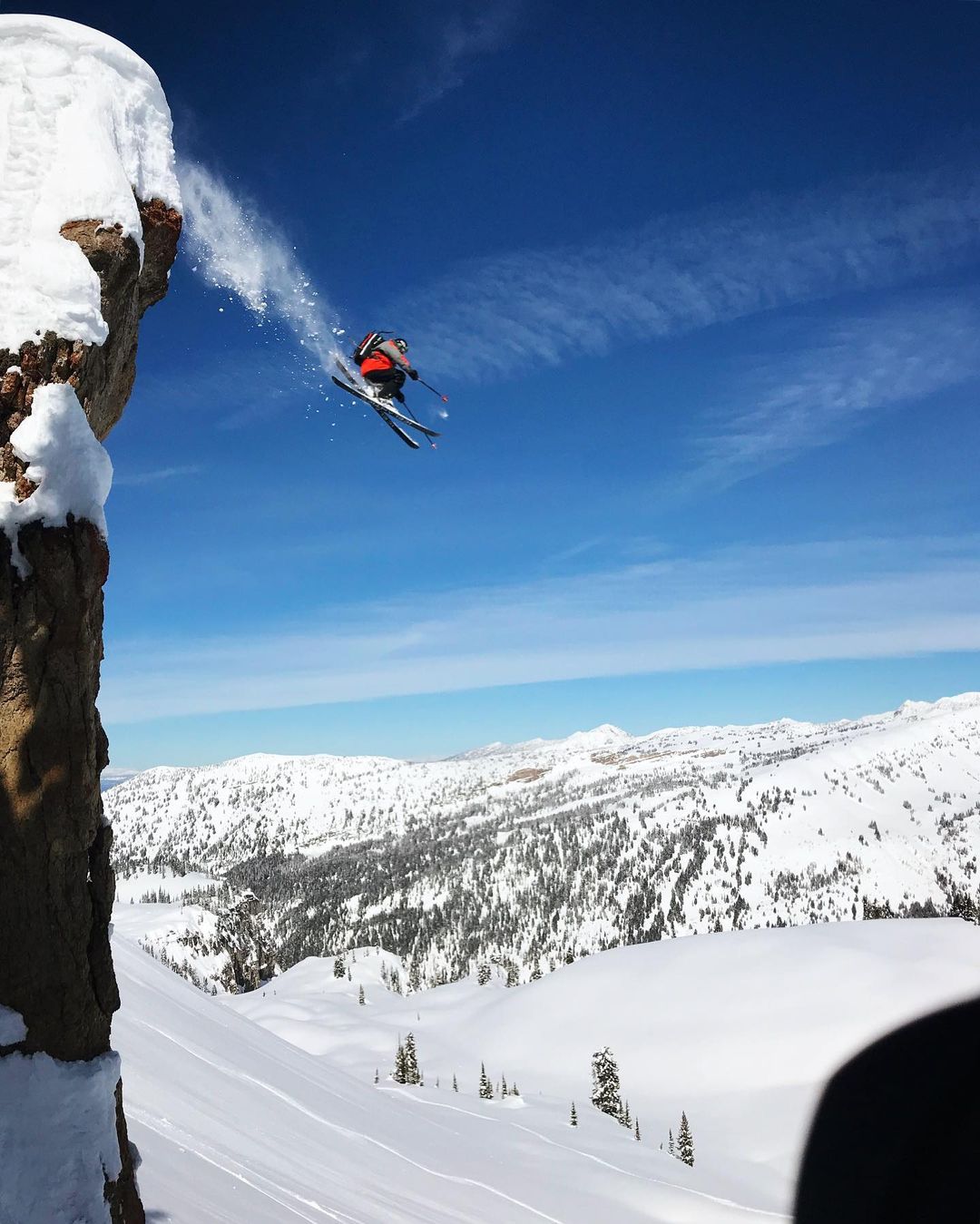 Julian Carr midair jumping off a cliff